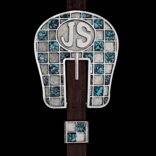 Our Rabicano Headstall Buckle is handcrafted on a German Silver base featuring our signature checkerboard pattern detailed with our Crush Stones in the color of your choice. In the center of the headstall customize the lettering to showcase your initials,